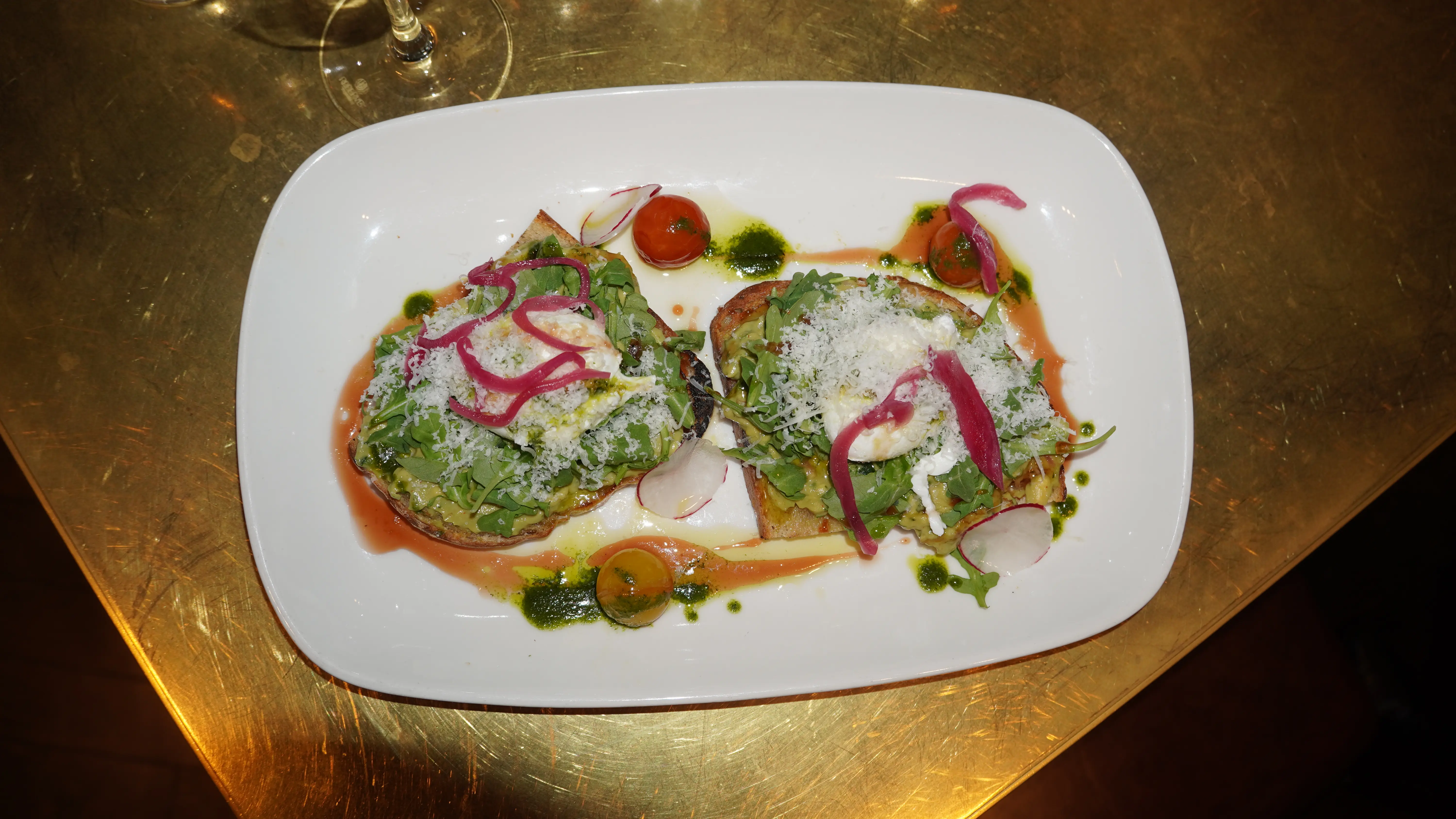 Open-faced crostini with pickled red onion, radish and grated cheese plated at our Calgary steakhouse