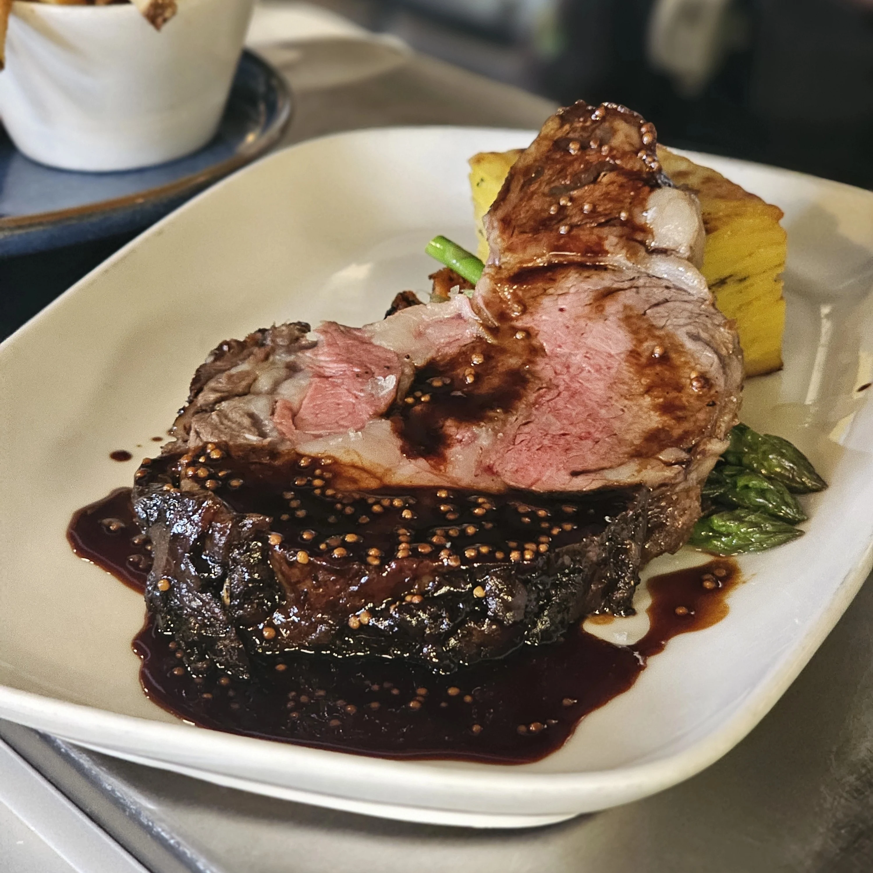 Herb-crusted rack of Alberta lamb carved into cutlets at notable - The Steakhouse, Calgary